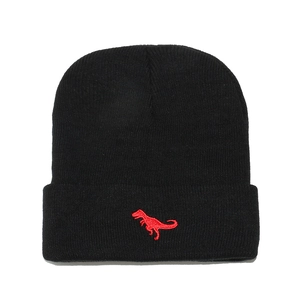 Kids black knitted beanie with a bright red dinosaur embroidery on the fold-up cuff