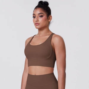 Close-up of high-elastic brushed fabric on dark brown sports bra and leggings set