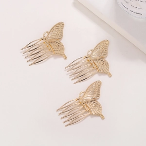 Three-piece gold butterfly hair comb set with intricate hollow wing design on white back