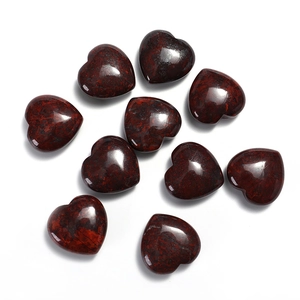 Top view of ten heart-shaped polished natural gemstones in dark reddish-brown hue