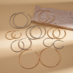 Minimalist geometric C-shaped stud earrings in gold and silver finish on stone base