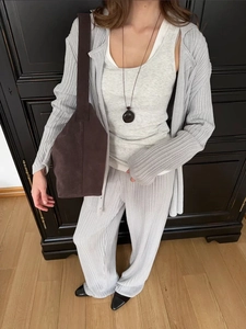 Detail of grey polo collar knit cardigan and wide-leg pants with soft texture