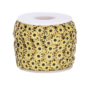 Macro shot of 10mm yellow daisy flower chain rolls in stainless steel for DIY jewelry
