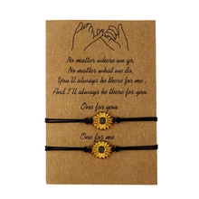 Detail of adjustable sunflower charm bracelets on a sentimental gift card with black cords