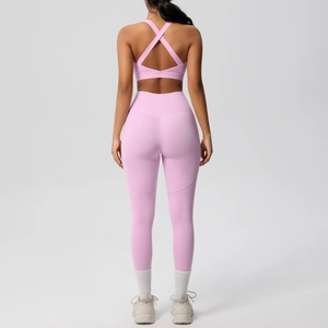 Detail view of the pink yoga set showing the cross-back sports bra and high-waist leggings