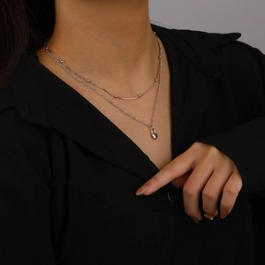 Double layered 925 sterling silver necklace with heart lock pendant on black background