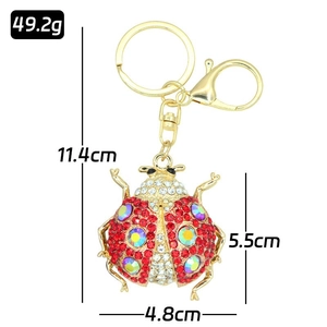 Detail view of ladybug keychain with dimensions and weight on white background