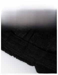 Detail of breathable black knitted fabric showing the wide moisture-wicking structure