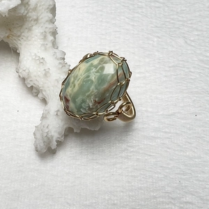 Macro view of handmade 14K gold filled wire wrapped green tiger eye stone ring detail