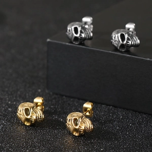 Macro shot of punk style skull studs in gold and silver finish stainless steel