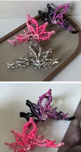 Detail of four butterfly hair claws with pearls and rhinestones in various colors