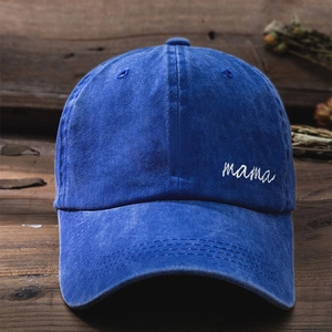 Close-up of white mama embroidery on washed denim baseball cap with vintage texture