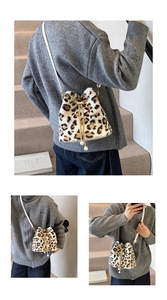 Detail of leopard print plush bucket bag with chain strap and drawstring closure