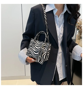 Close-up of zebra pattern handbag set and matching coin purse in premium faux leather