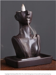 Detail of ceramic backflow incense burner showing smoke flowing from beauty sculpture