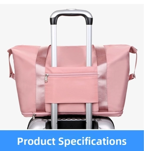 Pink waterproof travel bag detail showing the luggage handle sleeve and zipper pocket