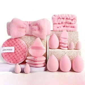 Pink makeup tool set including headband, wristbands and puffs on stone display
