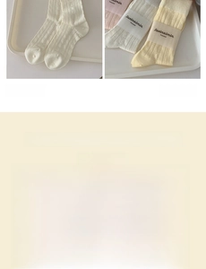 Detailed knit texture and bow accent on soft cream-colored mid-calf cotton socks