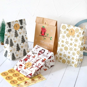 Detailed view of Christmas kraft paper gift bags with holiday stickers and festive patterns