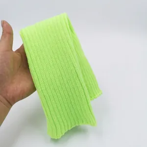 Detailed view of the neon green ribbed knit texture on these warm winter leg warmers