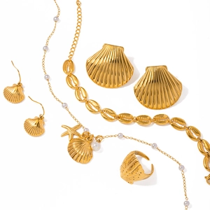 Golden ocean jewelry set with starfish, shell pendants, pearls and nautical elements