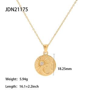 Detail view of gold celestial sun and moon pendant showing dimensions and chain length