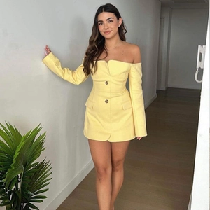 Detail of sexy yellow off-shoulder long sleeve mini dress with button decorations
