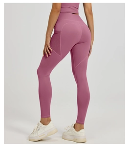 Detail view of high-waist yoga leggings with mesh side pockets and lifting back seam