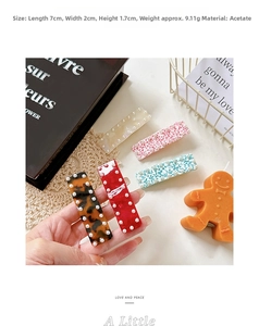 Detail view of rectangular acetate hair clips with inlaid pearls in five assorted colors