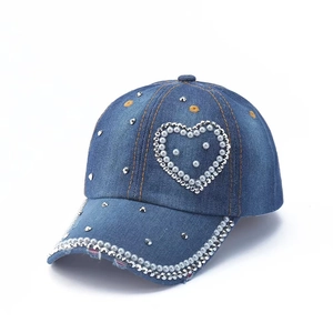 Blue denim baseball cap featuring pearl rhinestone heart and beaded brim details
