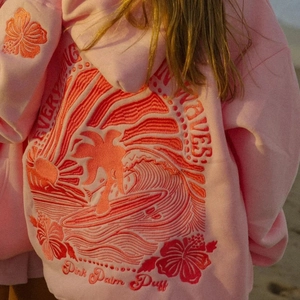 Detail of pink hoodie featuring high-quality tropical embroidery and 3D wave patterns