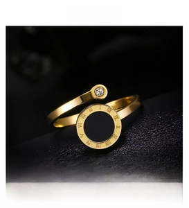 Detail of Roman numeral ring with black disc and sparkling diamond on black leather