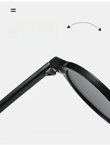 Detail of durable metal hinge on black oval sunglasses with reinforced screw design