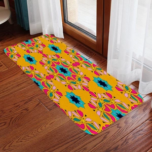 Detail of bohemian patterned yellow flannel absorbent floor mat on dark wood floor