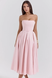 Detail of light pink corset midi dress featuring structured seams and waist bow