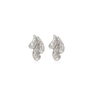 Macro view of silver textured earrings with liquid metal and lava-style pattern