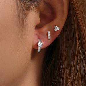 Close-up of triple silver earring set with cubic zirconia worn on earlobe