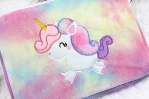 Close-up of unicorn embroidery on rainbow tie-dye plush 11-inch laptop sleeve bag