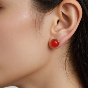 Elegant round S925 silver stud earring with red jasper and gold border on ear