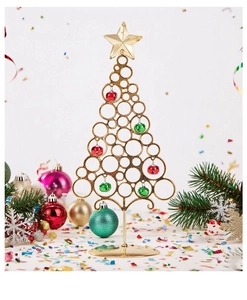 Close-up of golden iron Christmas tree with decorative red and green bells for desktop