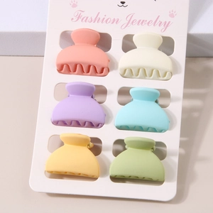 Set of six colorful matte mini hair claws in vibrant macaron colors on display card
