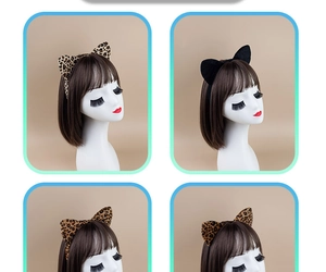 Detail of four leopard print and black plush cat ear headbands on model wig