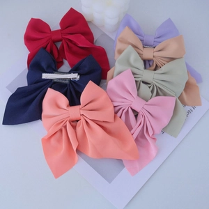 Detail of colorful bow hair clips set with metal alligator clips and chiffon fabric
