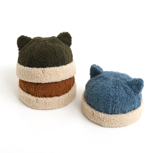 Close-up of soft fleece baby hats with cute bear ears and stylish color-block design