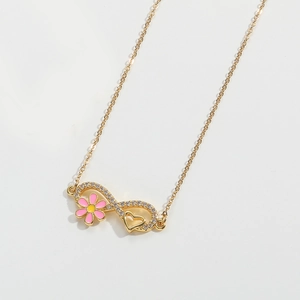 Macro view of infinity pendant with pink enamel flowers and white zircon stones