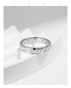 Close-up of S925 silver ring with mixed-cut cubic zirconia and inner metal hallmark