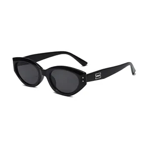 Retro black cat-eye sunglasses with thick frames and metallic B-logo temple detail