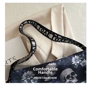 Detail of floral and skull print fabric on tote bag with wide branded shoulder strap