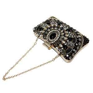 Close-up of luxury black evening clutch featuring intricate beadwork and sequins