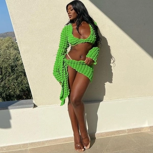 Detailed macro shot of vibrant green two-piece set featuring 3D textured bubble fabric